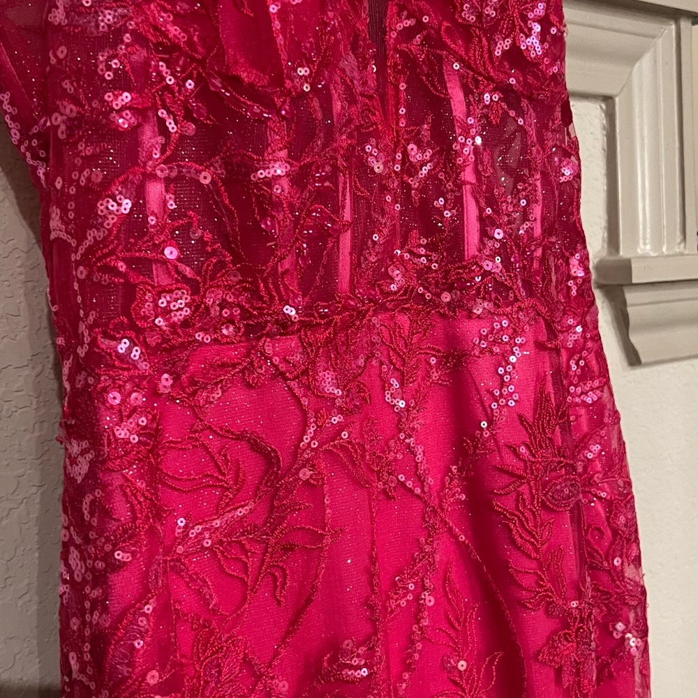 Beaded corset style prom dress w spaghetti straps and sequined flowing train.